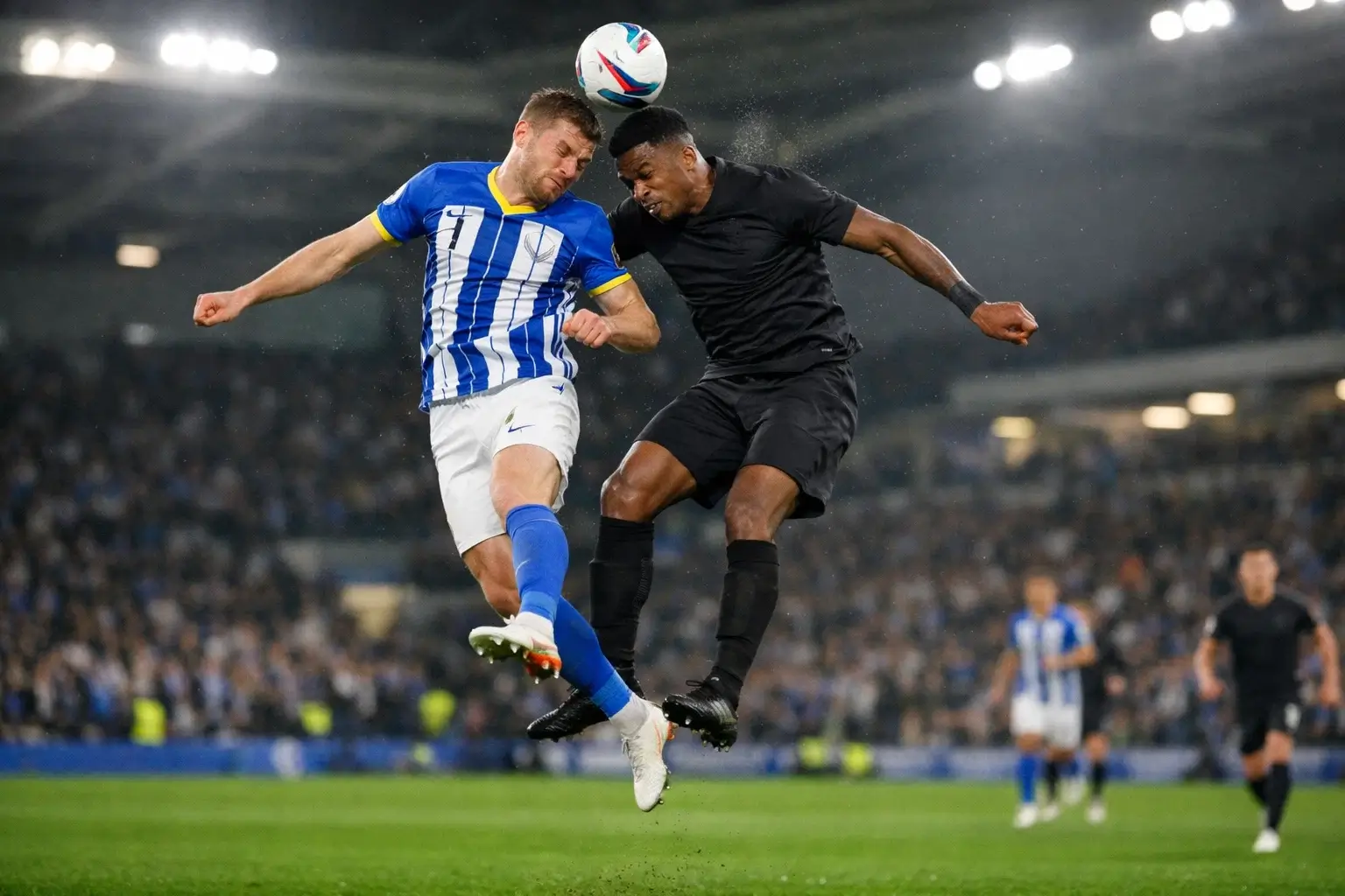 Football players from opposing teams challenging for a header during a competitive match