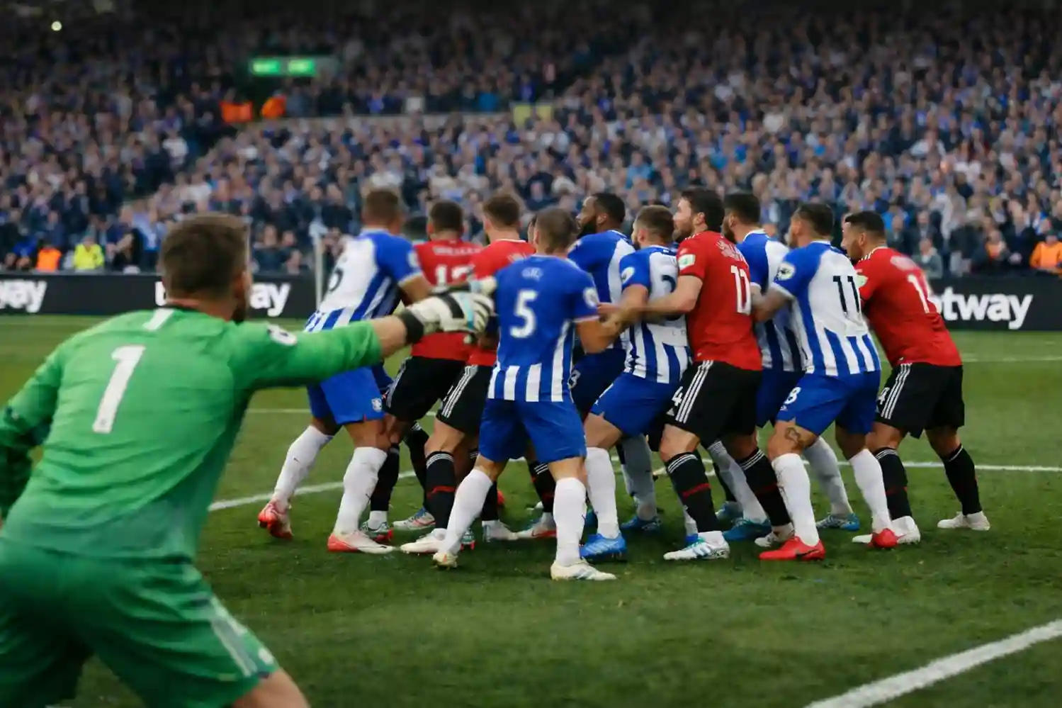 Defenders marking attackers inside the penalty box during a corner kick