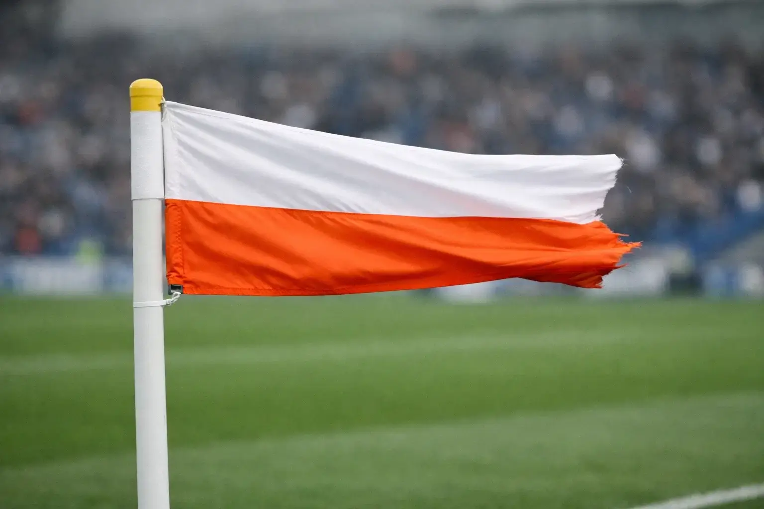 Corner flag blowing strongly in the wind at a football stadium