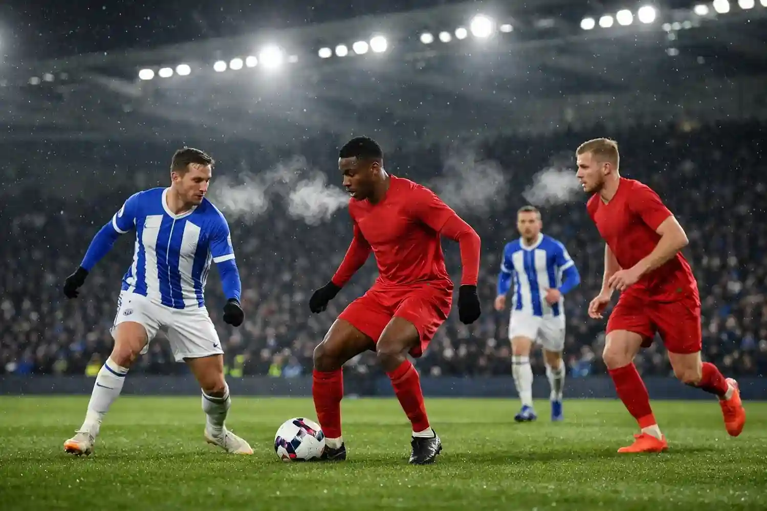 Football match being played under floodlights on a cold winter evening with visible breath from players